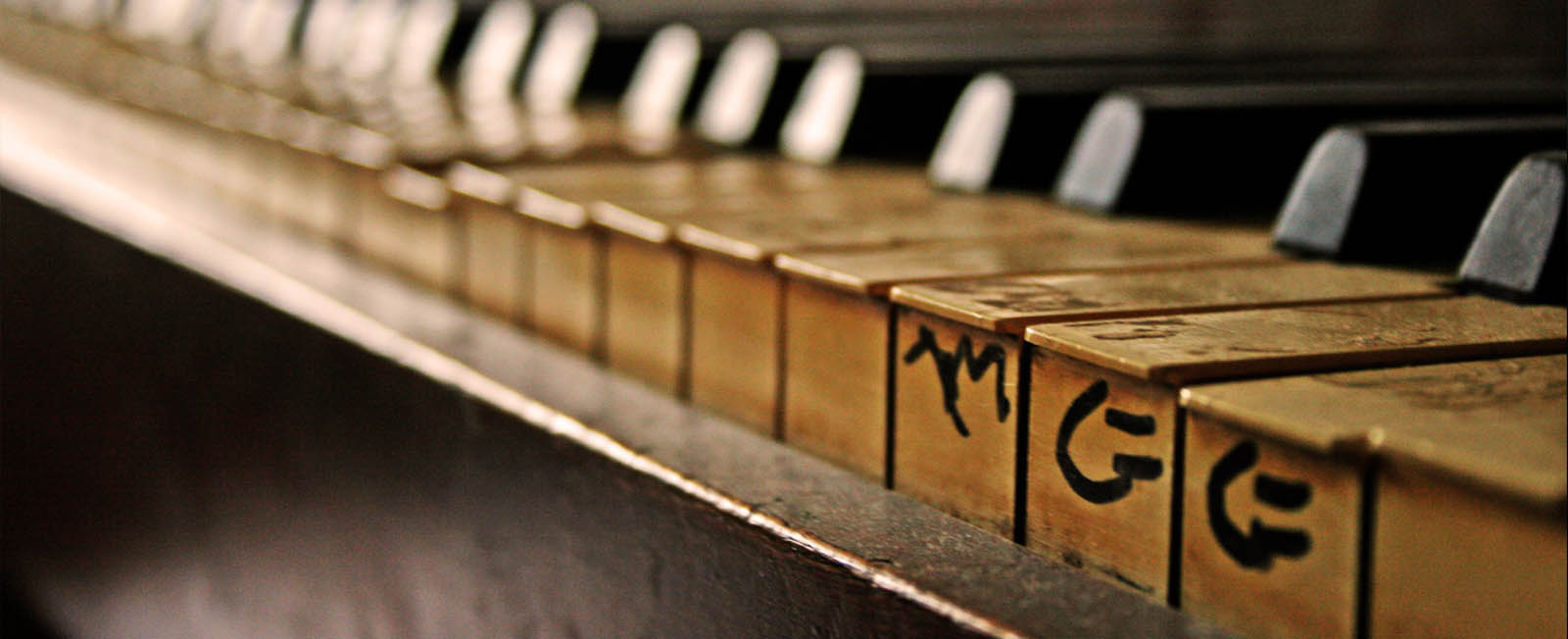 old piano with letters carved