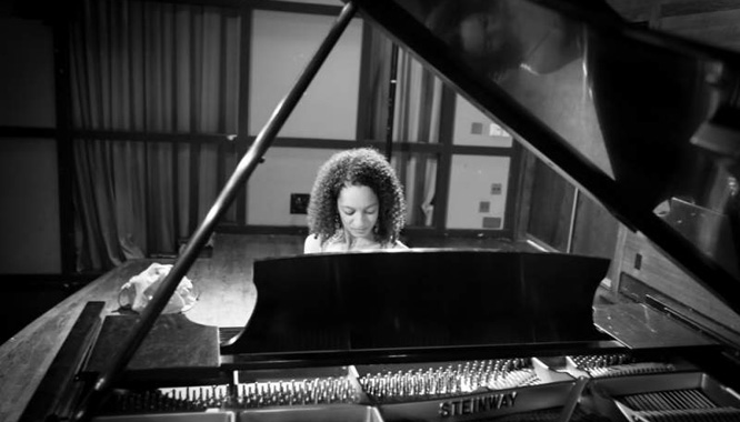 young adult playing piano at recital